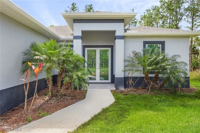 property entrance featuring french doors and a yard