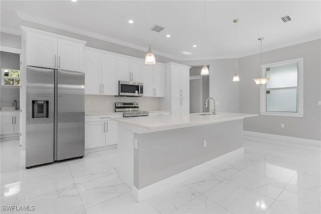 kitchen with stainless steel appliances, white cabinetry, hanging light fixtures, and a center island with sink