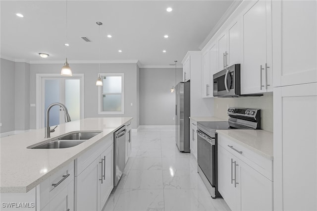 kitchen featuring sink, hanging light fixtures, stainless steel appliances, an island with sink, and white cabinets