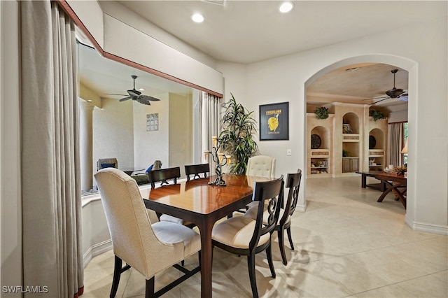 dining space featuring ornate columns, ceiling fan, and built in features