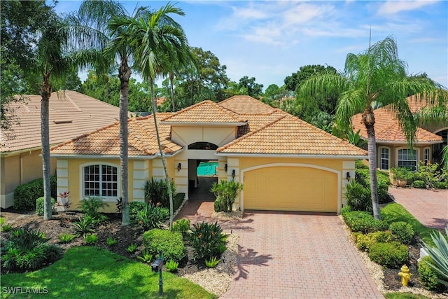 mediterranean / spanish house with a garage