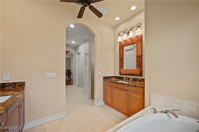 bathroom featuring a bathtub, ceiling fan, tile patterned flooring, and vanity