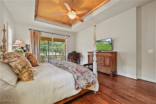 bedroom featuring access to exterior, dark hardwood / wood-style flooring, a raised ceiling, ceiling fan, and crown molding