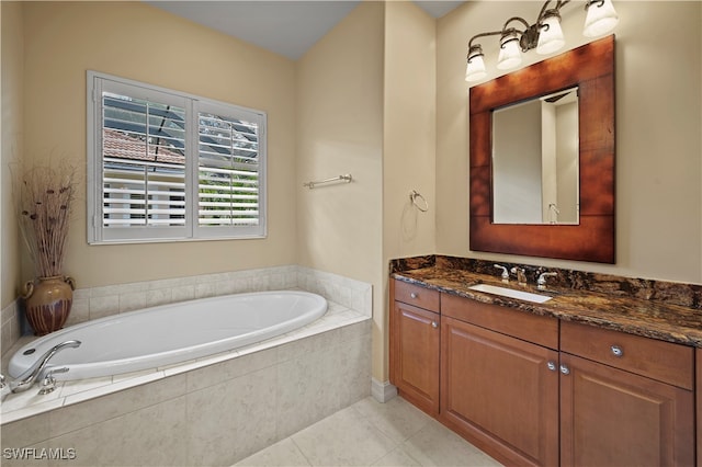 bathroom featuring tiled bath and vanity