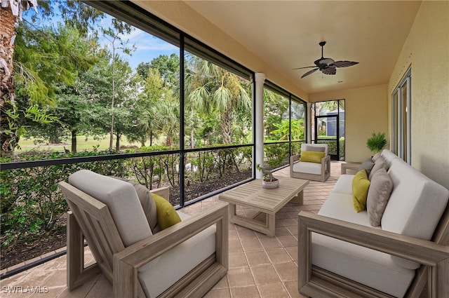 sunroom / solarium featuring ceiling fan