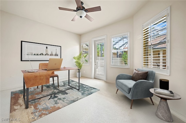 office featuring ceiling fan and light carpet