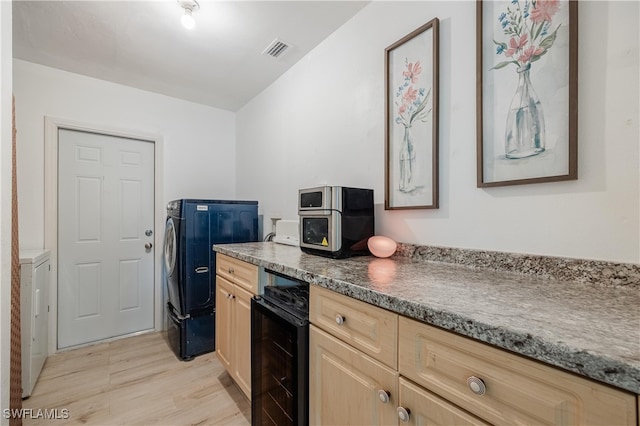 kitchen featuring light brown cabinets, light hardwood / wood-style flooring, and wine cooler