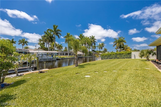 view of yard with a dock and a water view