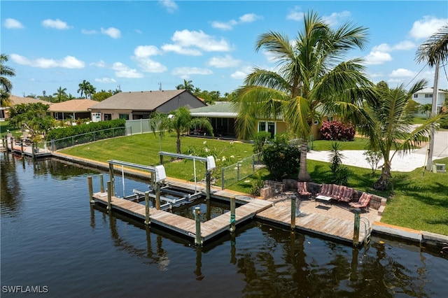 dock area with a lawn and a water view