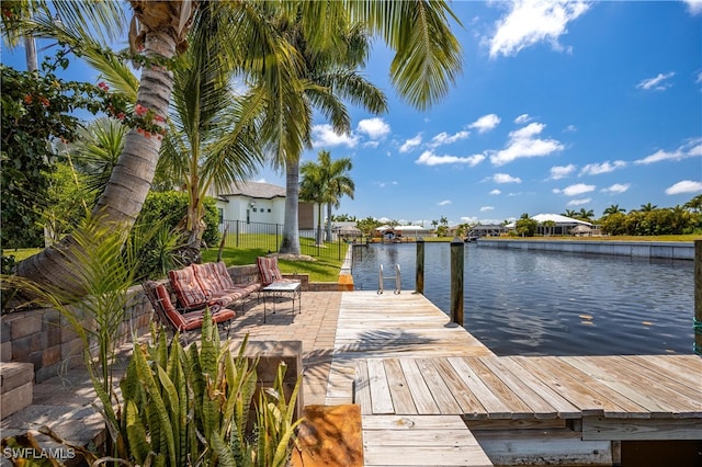 view of dock featuring a patio area and a water view