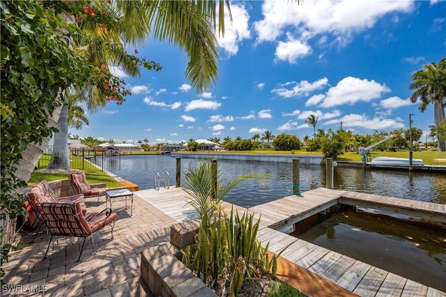 dock area with a patio area and a water view