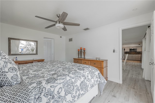 bedroom with light wood-type flooring, a closet, and ceiling fan