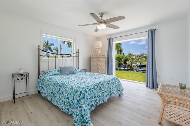 bedroom with access to outside, light hardwood / wood-style flooring, and ceiling fan