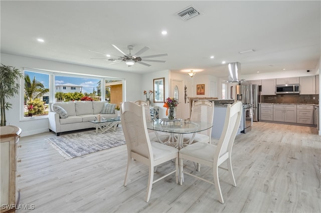 dining room featuring light hardwood / wood-style flooring and ceiling fan