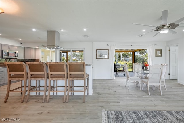 dining space featuring ceiling fan, plenty of natural light, and light hardwood / wood-style floors