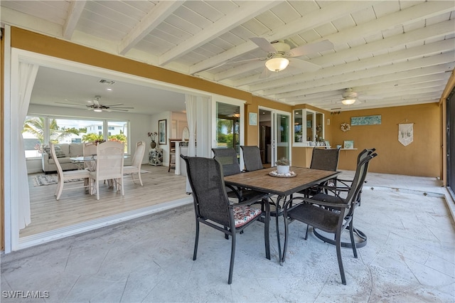 dining area featuring beamed ceiling and light hardwood / wood-style floors