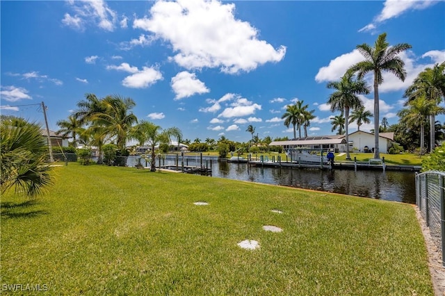 dock area featuring a yard and a water view