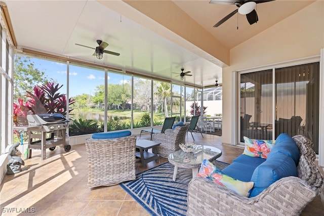 sunroom / solarium featuring lofted ceiling, a water view, and ceiling fan