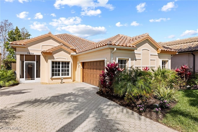 mediterranean / spanish-style house with a garage