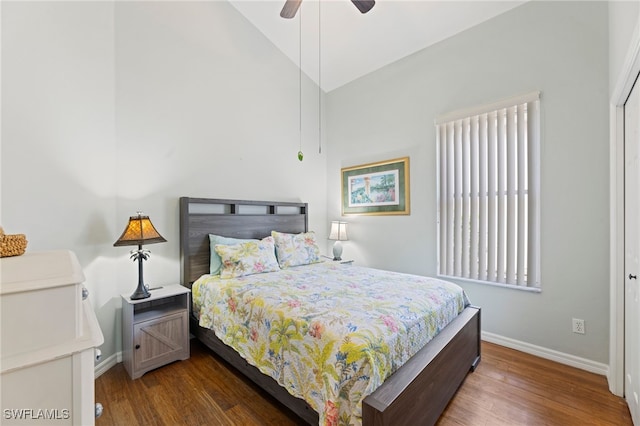 bedroom with vaulted ceiling, ceiling fan, a closet, and dark hardwood / wood-style flooring