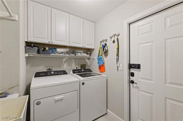 laundry area featuring cabinets, sink, and washer and clothes dryer