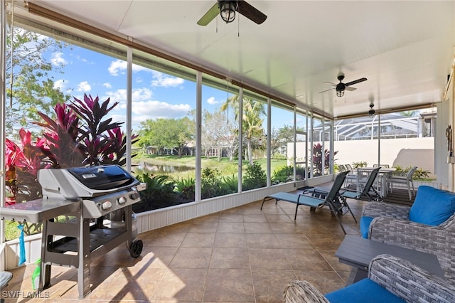 sunroom / solarium featuring ceiling fan