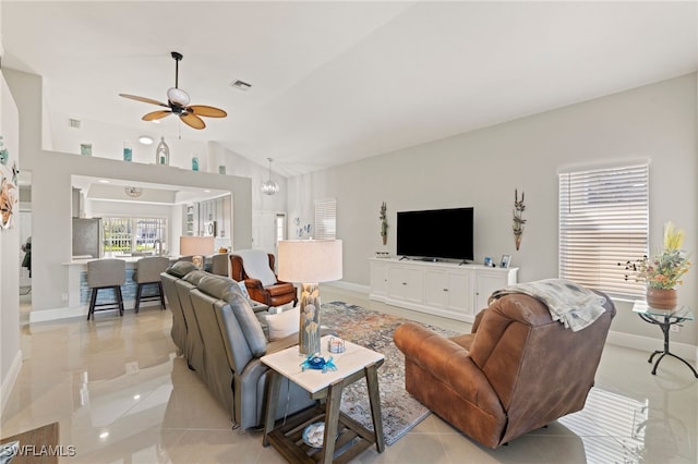 living room with light tile patterned flooring, ceiling fan, and high vaulted ceiling