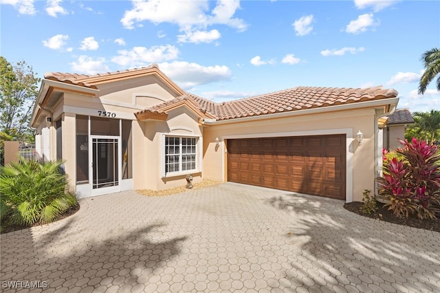 mediterranean / spanish-style house with a garage