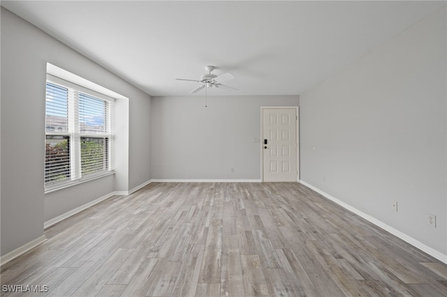 empty room featuring ceiling fan and light hardwood / wood-style floors