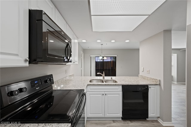 kitchen with light hardwood / wood-style floors, white cabinetry, sink, and black appliances