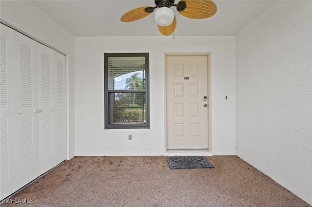 view of exterior entry featuring ceiling fan