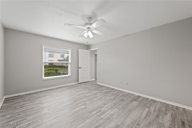 empty room with light hardwood / wood-style flooring and ceiling fan