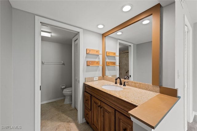 bathroom featuring vanity, tile patterned flooring, and toilet