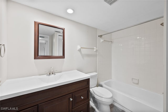 full bathroom featuring toilet, tiled shower / bath combo, and vanity