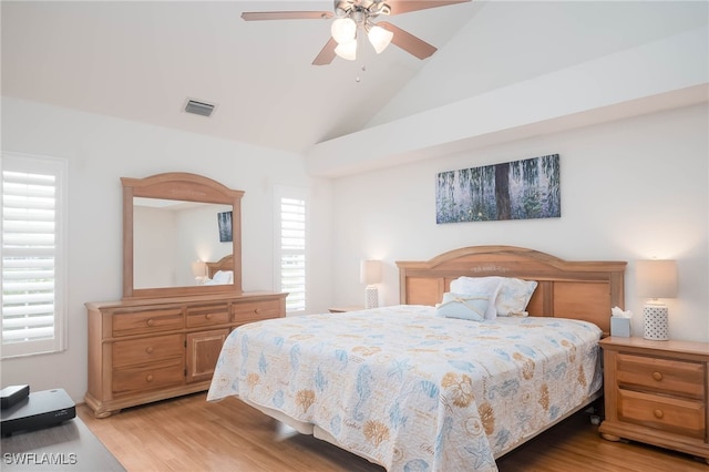 bedroom with high vaulted ceiling, light hardwood / wood-style flooring, multiple windows, and ceiling fan