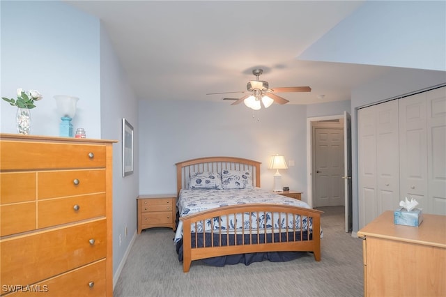 carpeted bedroom featuring ceiling fan and a closet