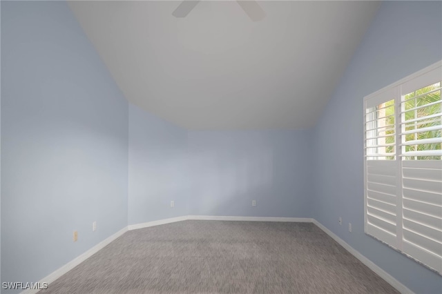 empty room featuring lofted ceiling and carpet floors