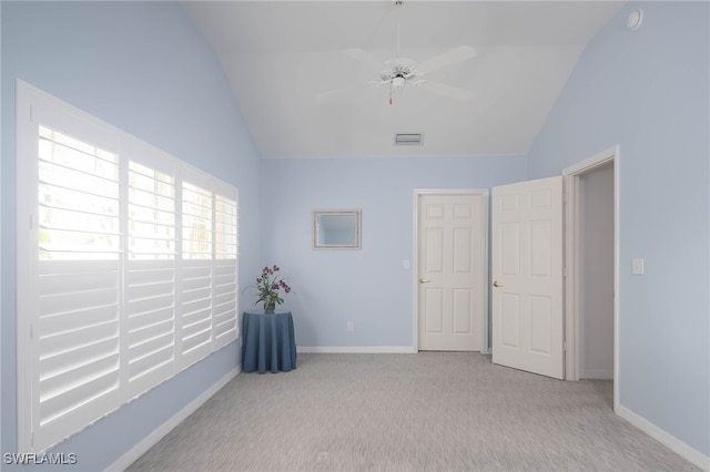 unfurnished room featuring light carpet, ceiling fan, and vaulted ceiling