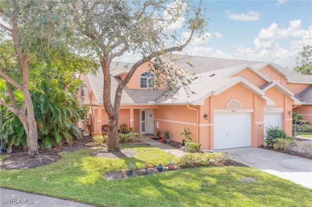 view of front of house featuring a garage and a front lawn