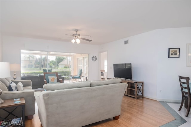 living room with light wood-type flooring and ceiling fan