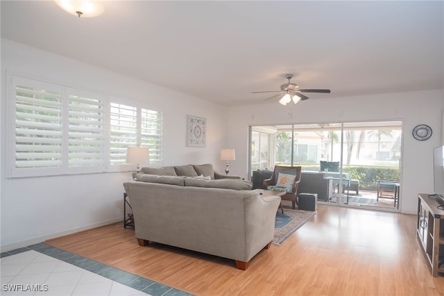 living room featuring ceiling fan, a healthy amount of sunlight, and light hardwood / wood-style flooring