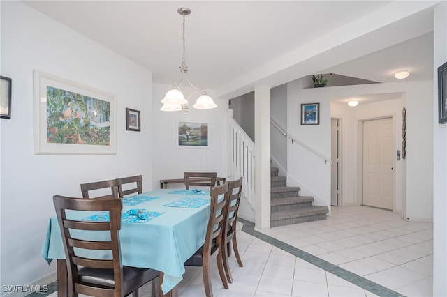 dining room with an inviting chandelier and light tile patterned floors