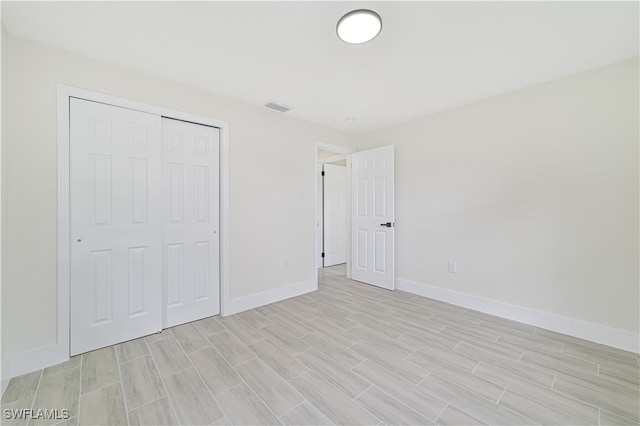 unfurnished bedroom featuring a closet and light hardwood / wood-style flooring