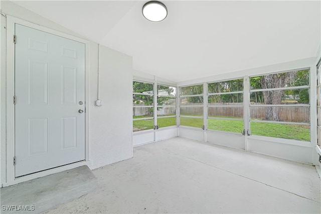 unfurnished sunroom featuring a wealth of natural light and lofted ceiling