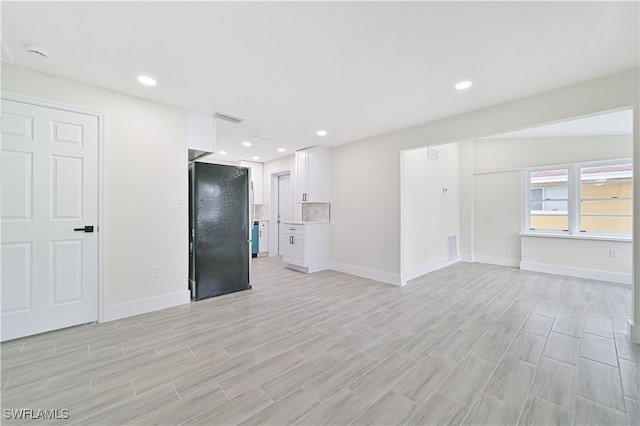 empty room with light hardwood / wood-style flooring