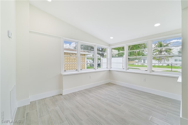 unfurnished sunroom featuring lofted ceiling