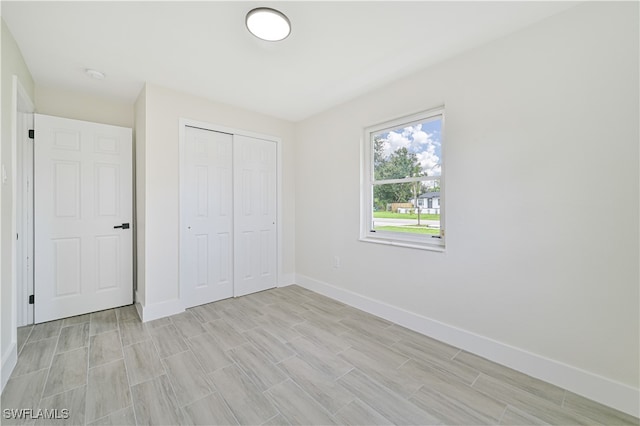 unfurnished bedroom featuring a closet and light hardwood / wood-style flooring