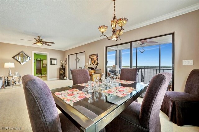 carpeted dining area with crown molding, ceiling fan with notable chandelier, and a textured ceiling