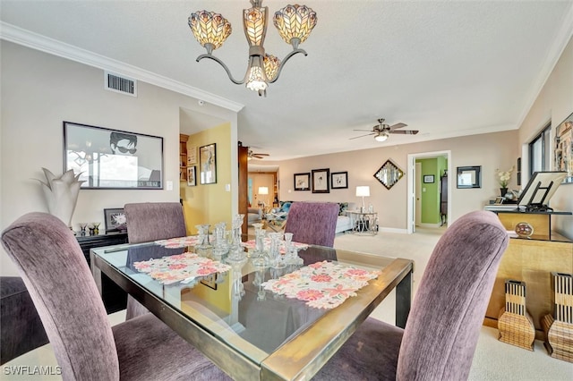 carpeted dining area with ceiling fan with notable chandelier, crown molding, and a textured ceiling