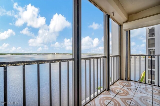 unfurnished sunroom with a water view